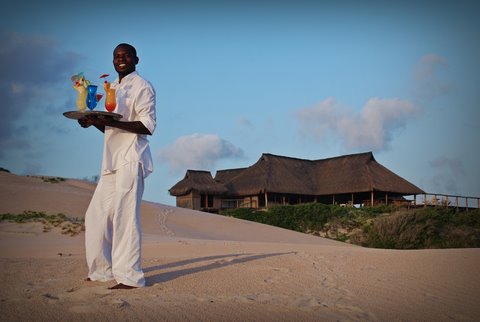 A frienly Ziggy offering colourful cocktails to guests on the beach infront of Nyati